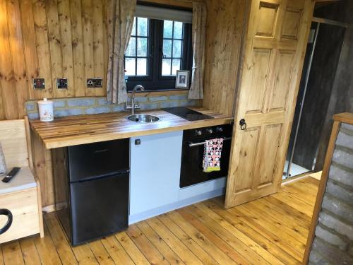 a kitchen with a black and white dishwasher at Goodwin Farm in Northiam
