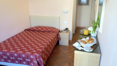 Postel nebo postele na pokoji v ubytování Hotel Rita Major