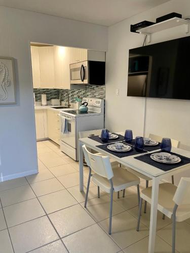 a kitchen with a table and chairs in a kitchen at Gorgeous Beachy Chic Condo in Key Biscayne in Miami
