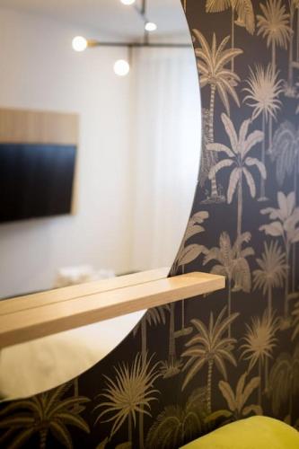 a room with a wall with palm trees wallpaper at Palms Little Italy Studio with full bathroom by Denstays in Montréal