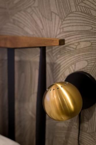 a gold helmet sitting on top of a bed at Palms Little Italy Studio with full bathroom by Denstays in Montréal