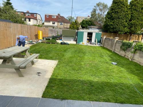 a man standing in a yard with a picnic table at N D Room in Oxford