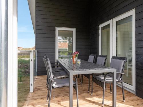a dining room table and chairs on a patio at Holiday Home Raakel - 950m from the sea by Interhome in Torsted