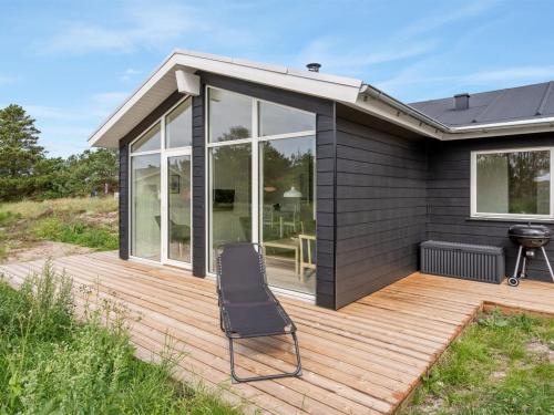 a deck with a chair on top of a house at Holiday Home Raakel - 950m from the sea by Interhome in Torsted