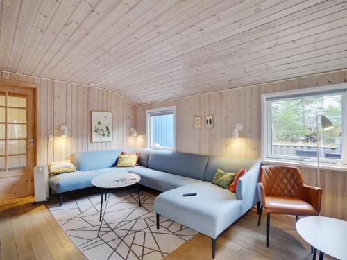 a living room with a blue couch and chairs at Holiday Home Anegrete - 900m from the sea in NW Jutland by Interhome in Torsted