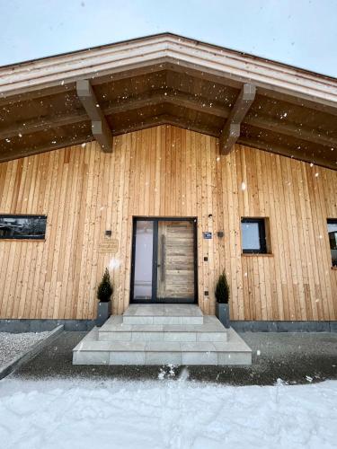 a building with a door with snow on it at Ferienwohnung Bergliebe in Sankt Johann in Tirol