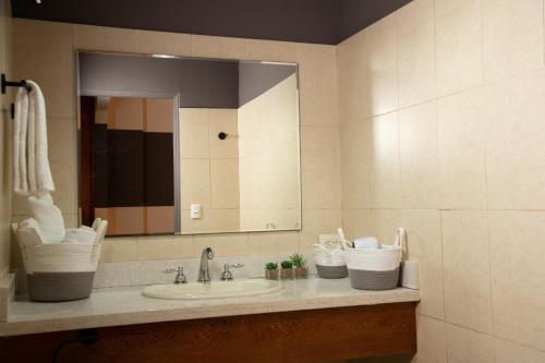 a bathroom with a sink and a mirror at MARINN Tropical Vibes Hotel in Panama City