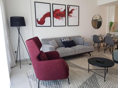 a living room with a couch and a table at Stylish 1 Bedroom Apartment Near Burj Al Arab (Madinat Jumeirah) in Dubai