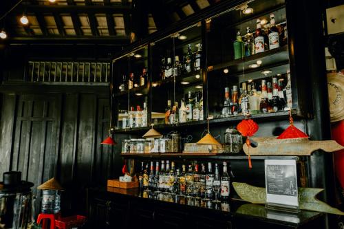 a bar with a lot of bottles of alcohol at Anja Beach Resort & Spa in Phu Quoc