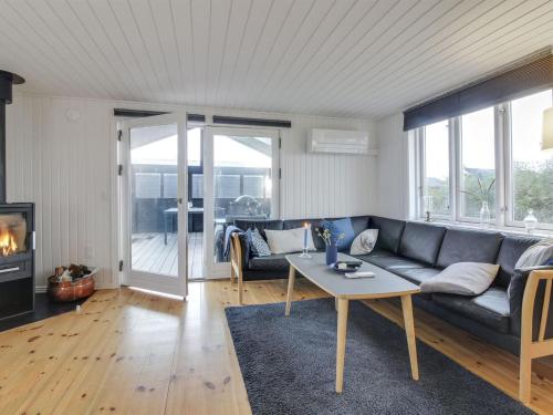 a living room with a couch and a table at Holiday Home Nehat - 300m from the sea in NW Jutland by Interhome in Løkken
