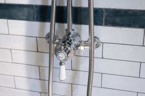 a shower in a bathroom with a hose at Harrogate Victorian Luxury in Harrogate