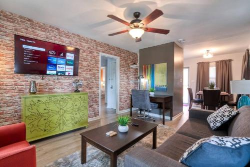 a living room with a couch and a brick wall at Trendy Escape ◉ California King bed awaits! in Charlotte