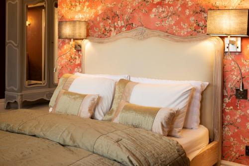 a bedroom with a large white bed with pillows at Harrogate Victorian Luxury in Harrogate