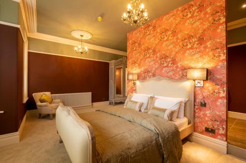 a bedroom with a large bed and a painting on the wall at Harrogate Victorian Luxury in Harrogate