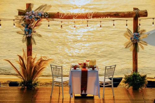 a table and chairs with a view of the water at Anja Beach Resort & Spa in Phu Quoc