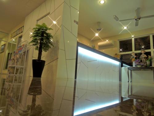 a room with a potted plant on a glass wall at Hotel Seri Nilai in Nilai