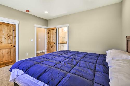 a bedroom with a large blue comforter on a bed at Chic Willamette Valley Home with Deck and Vineyard! in Gaston