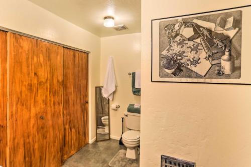 a bathroom with a toilet and a picture on the wall at Cozy Studio Near Hiking and Skiing, Walk to Downtown in Mount Shasta