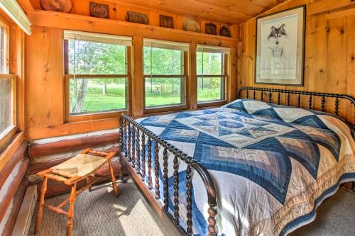 ein Schlafzimmer mit einem Bett in einem Blockhaus in der Unterkunft Wilderness Acres Retreat on Bear Lake! in McGrath