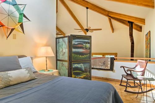 a bedroom with a bed and a ceiling fan at Forested Pentwater Vacation Rental - Walk to Beach in Pentwater