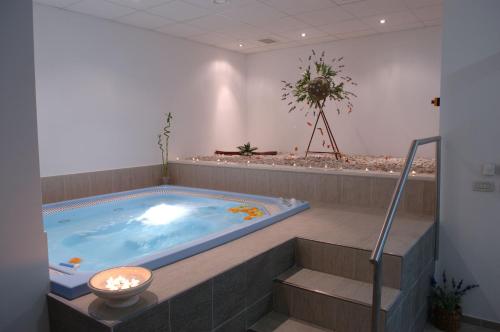 a jacuzzi tub in a room with stairs at Apartments Marija in Postira