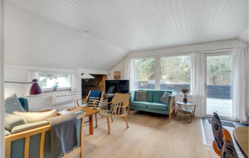 a living room with a couch and a table at Holiday Home Klydevej Hurup Thy Xi in Sindrup