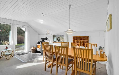 a kitchen and dining room with a table and chairs at Holiday Home Klydevej Hurup Thy Xi in Sindrup