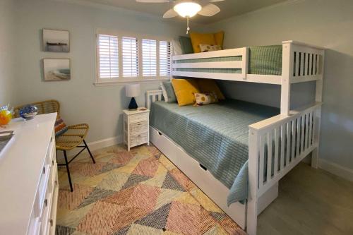 a childs bedroom with a bunk bed and a desk at Hilton Head Resort Getaway - Walk to Beach! in Hilton Head Island