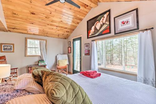 a bedroom with a bed and a large window at Pocono Home with Fire Pit 1 Mi to State Forest! in East Stroudsburg