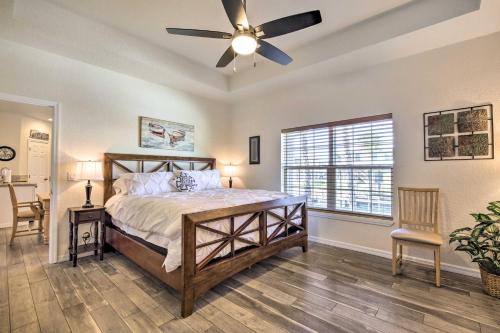 a bedroom with a bed and a ceiling fan at Canalside Crystal River Home with Dock and Kayaks in Crystal River