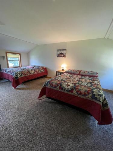 a bedroom with two beds in a room at LOON LODGE LIMIT 8 home in Standish