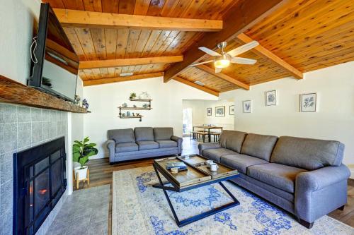 a living room with a couch and a fireplace at Dog-Friendly Oakhurst Home Walk to Downtown! in Oakhurst