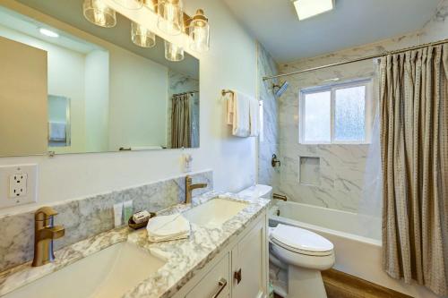a bathroom with a tub and a toilet and a sink at Dog-Friendly Oakhurst Home Walk to Downtown! in Oakhurst