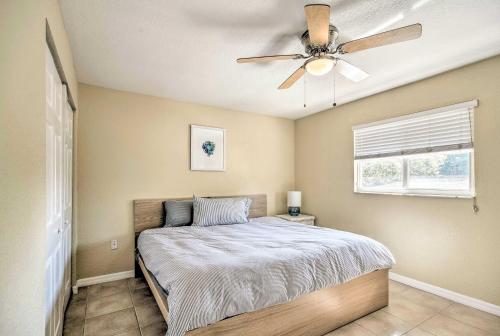 a bedroom with a bed with a ceiling fan at Sunny Indian Rocks Beach Condo Steps to Gulf! in Clearwater Beach