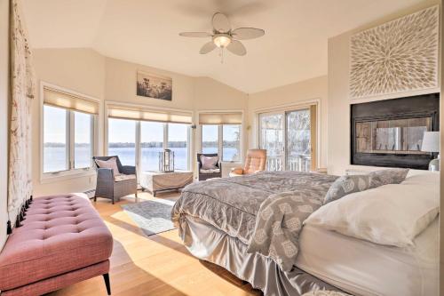 a bedroom with a bed and a couch and windows at Rhode Island Retreat with Kayaks, Deck and Pond Access in South Kingstown