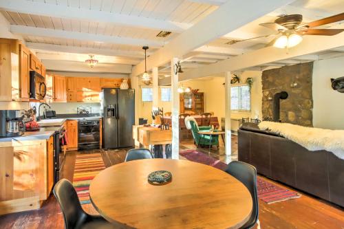 a kitchen and living room with a wooden table and chairs at Gilford Cabin - 2 Mi to Gunstock Mountain Resort! in Gilford
