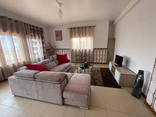 a living room with a couch and a tv at Prothea Home in Vila Chã