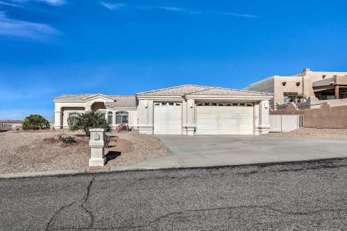 a large white house with a garage on a street at Cozy Lake Havasu House with Views - 1 Mi to Water! in Lake Havasu City