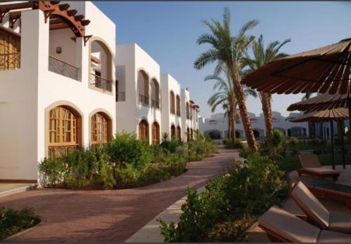 a building with a walkway next to a resort at Reale savoia in Sharm El Sheikh