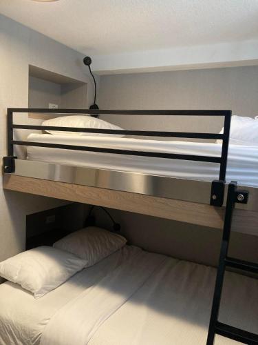 two bunk beds in a room with a bed at Lake Louise Inn in Lake Louise
