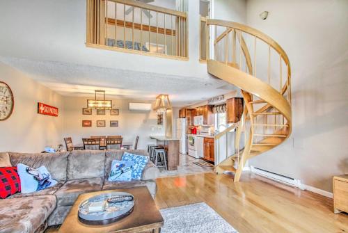 a living room with a couch and a spiral staircase at Ski Condo with Pool, Close to Story Land and Attitash! in Bartlett