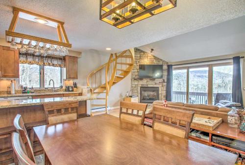 a kitchen and living room with a couch and a fireplace at Ski Condo with Pool, Close to Story Land and Attitash! in Bartlett