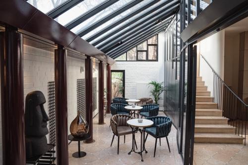 a room with tables and chairs and stairs at Domicil Hotel Bonn in Bonn