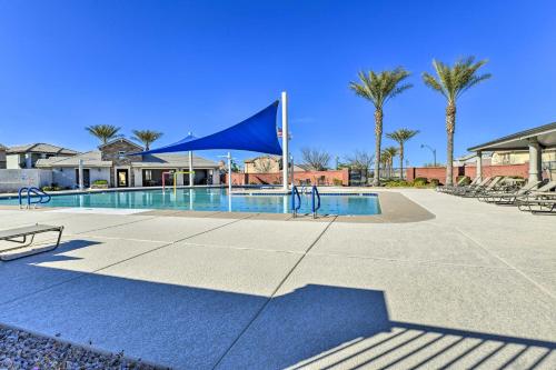 a swimming pool with a blue tent and palm trees at Patio and Balcony Spacious Gilbert Getaway! in Gilbert