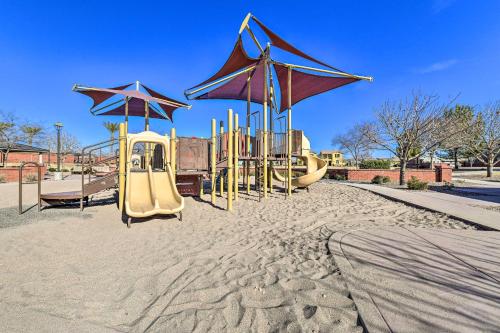 a playground with slides and umbrellas in the sand at Patio and Balcony Spacious Gilbert Getaway! in Gilbert