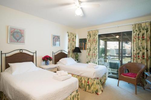 a bedroom with two beds and a balcony at Fisherman's Recess in Ponte Vedra Beach