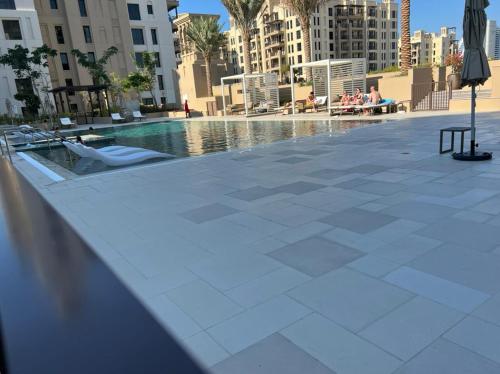 a swimming pool in the middle of a city with buildings at Stylish 1 Bedroom Apartment Near Burj Al Arab (Madinat Jumeirah) in Dubai