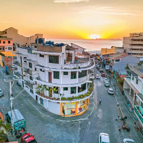 a city street at sunset with a large building at Pousada Vieira in Arraial do Cabo