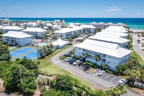 an aerial view of a resort with a parking lot at Short walk or shuttle to wide open public beach! in Santa Rosa Beach
