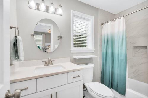 a bathroom with a toilet and a sink and a mirror at Short walk or shuttle to wide open public beach! in Santa Rosa Beach